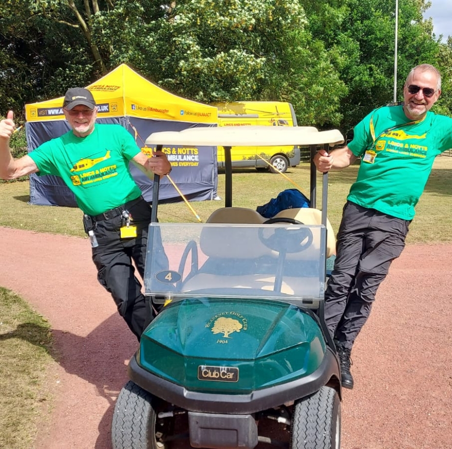 Fundraisers standing on a golf cart