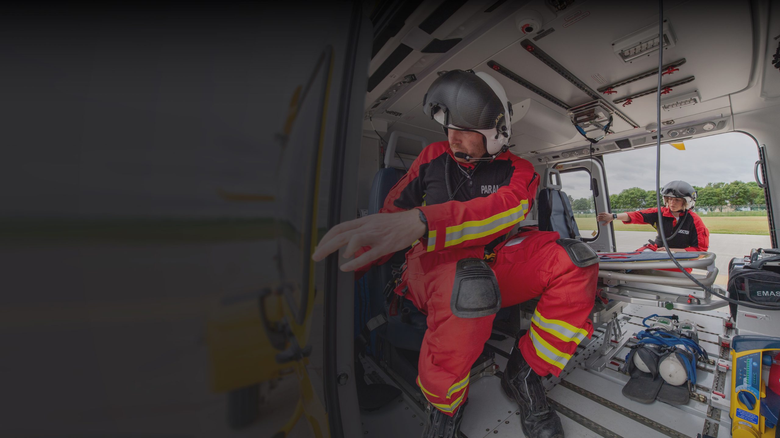 Doctor and paramedic getting into Lincs & Notts Air Ambulance helicopter