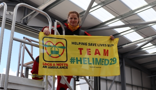 Paramedic holding Team Helimed 29 flag