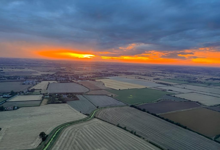Sunset view over fields from the helicopter