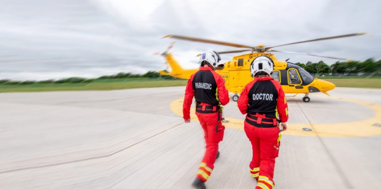 Doctor and paramedic walking to helicopter