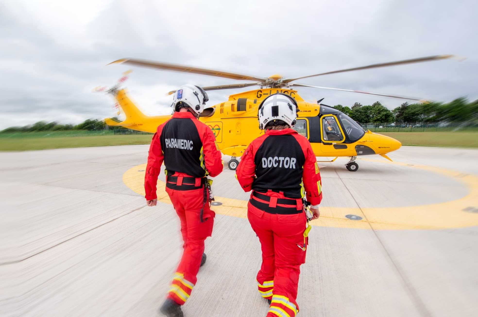 Doctor and paramedic walking to helicopter