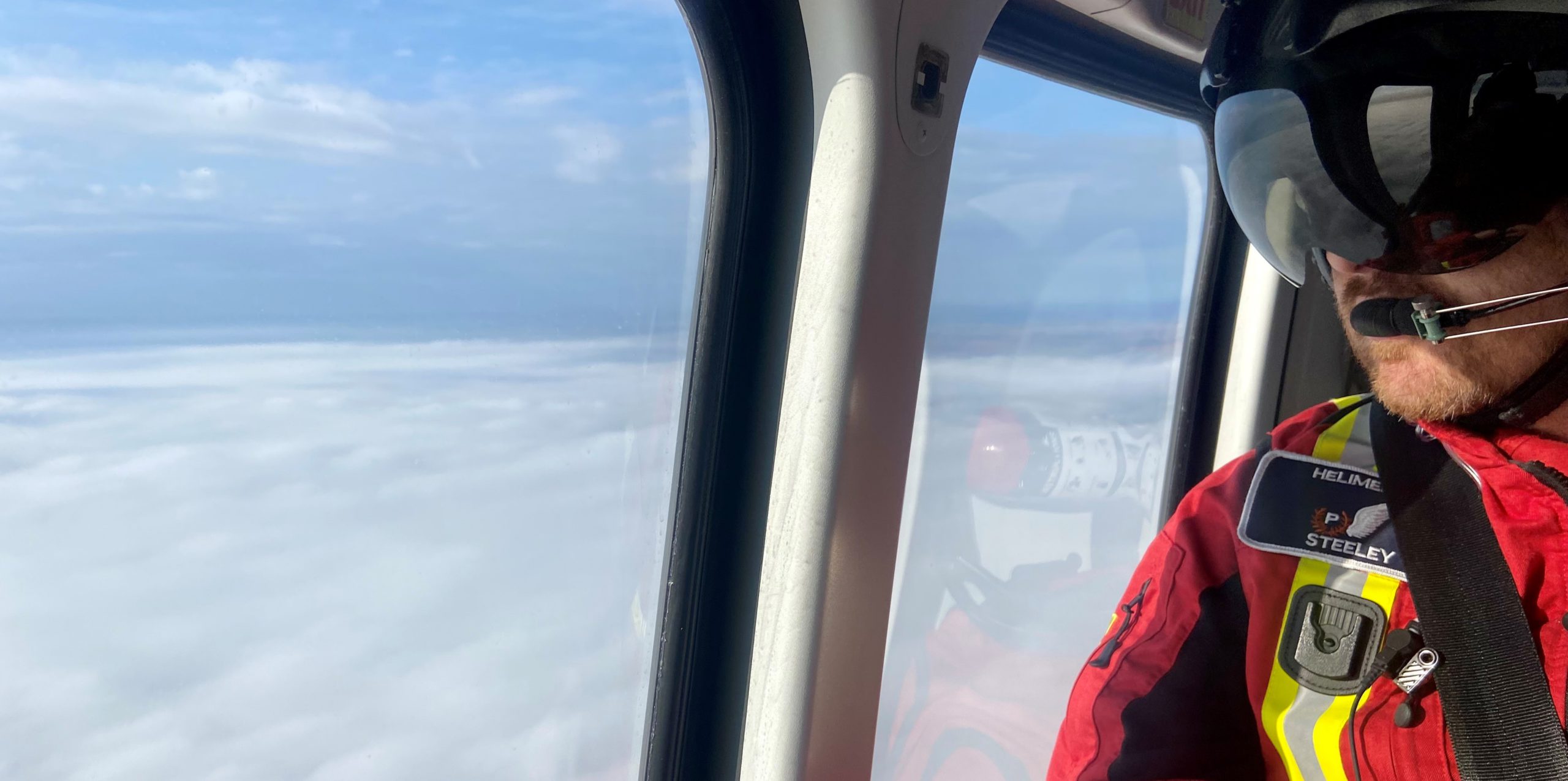 Paramedic in helicopter during flight