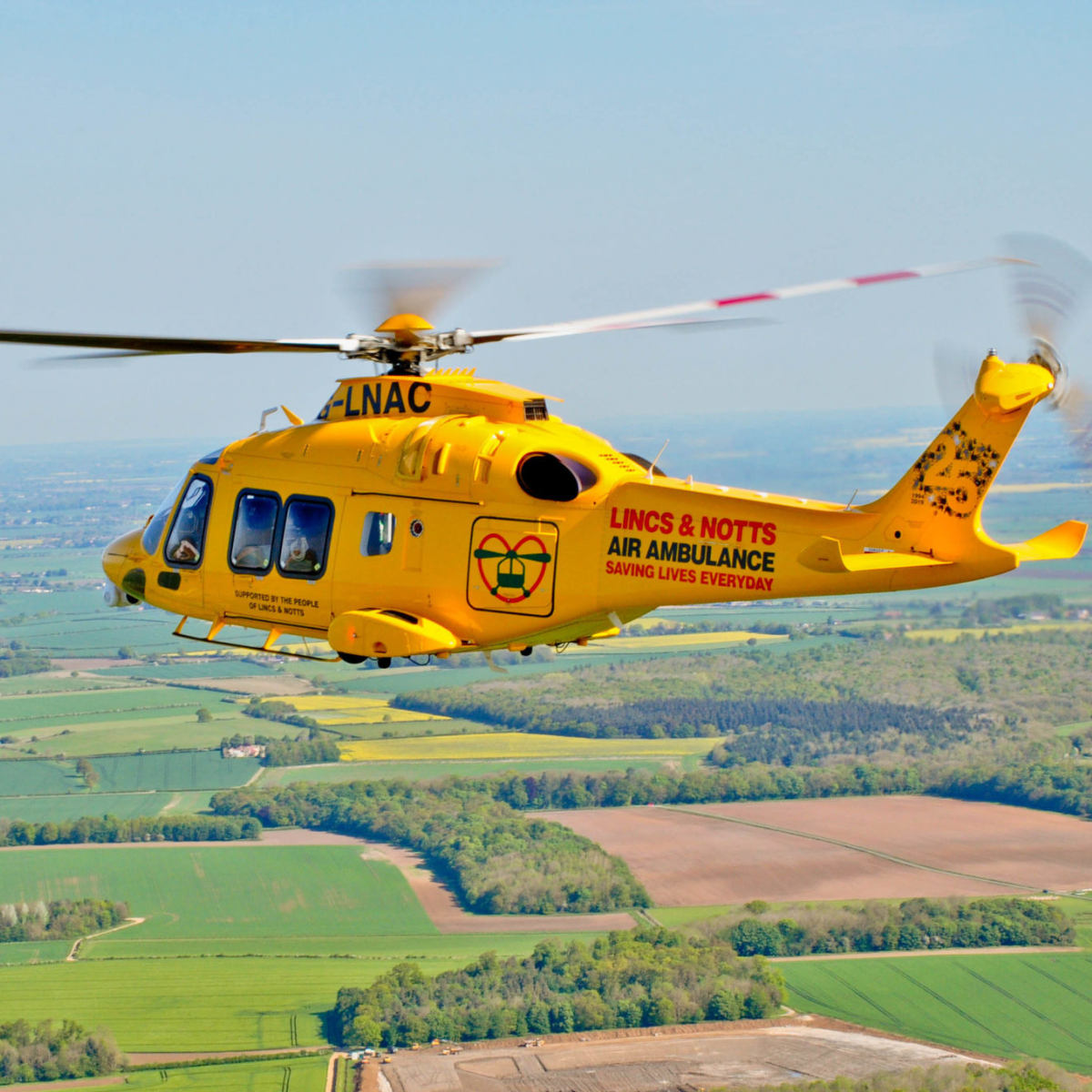 Our history archive showing G-LNAC helicopter flying over countryside