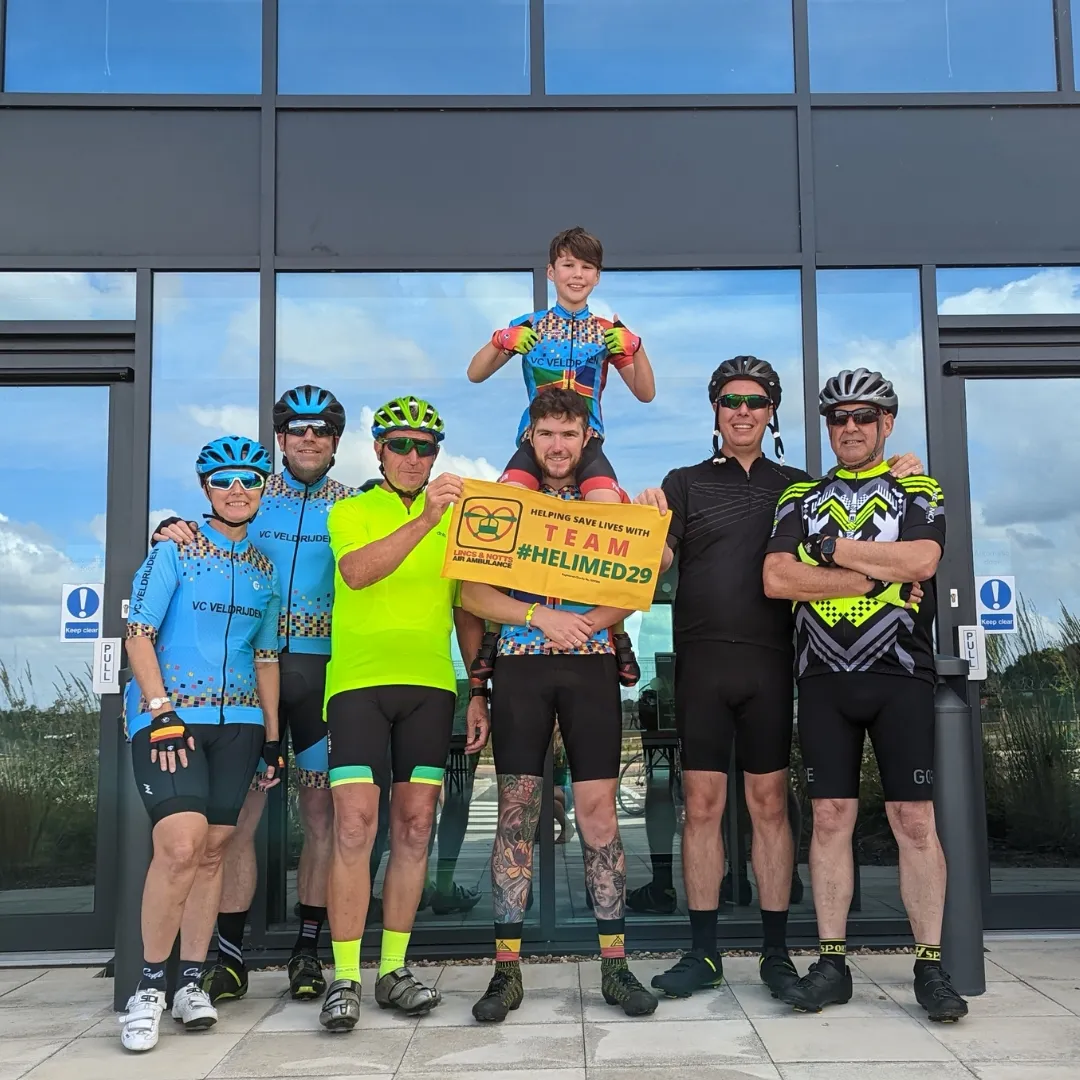 Past patient finishing cycling fundraiser outside Lincs & Notts Air Ambulance HQ