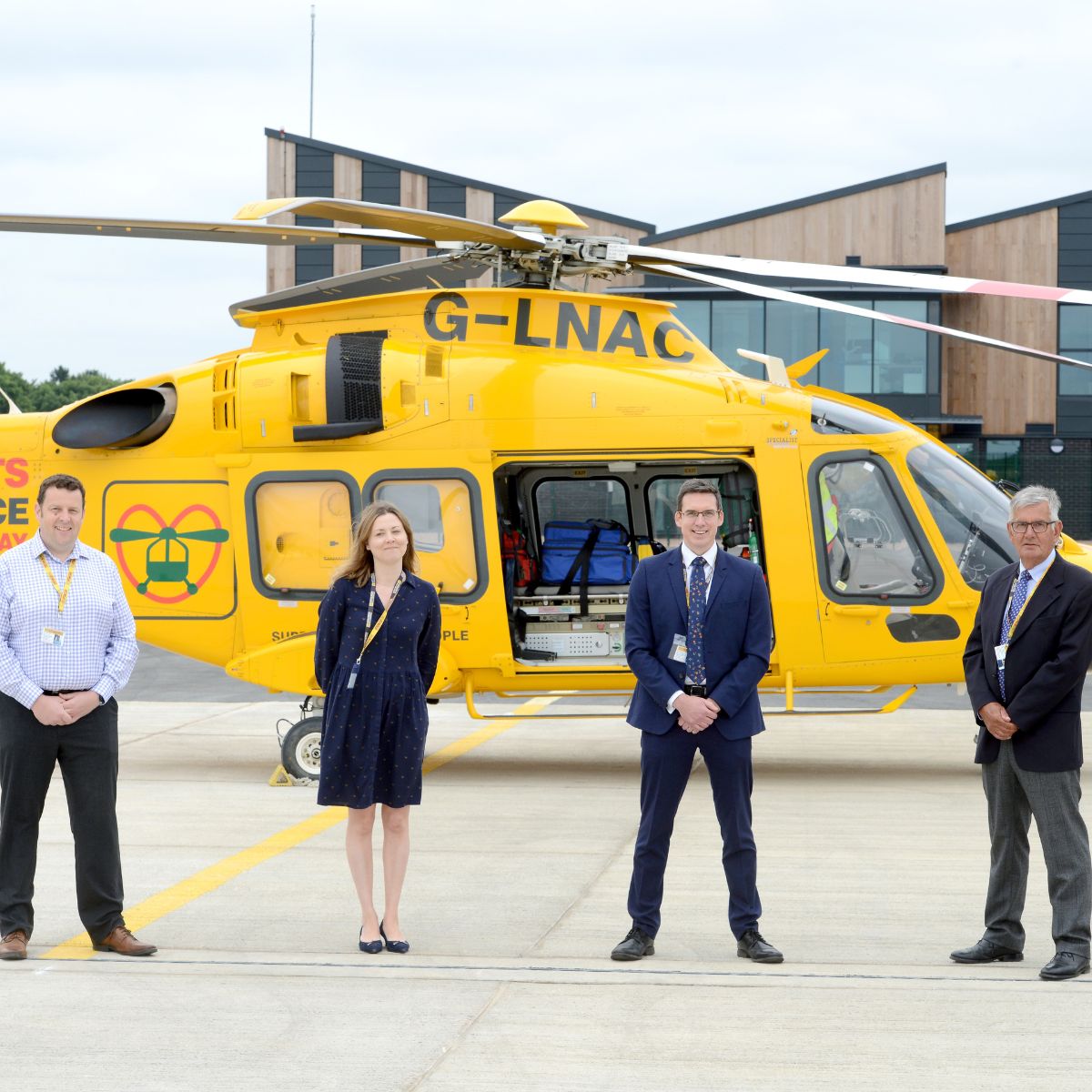LNAA board of trustees in front of helicopter