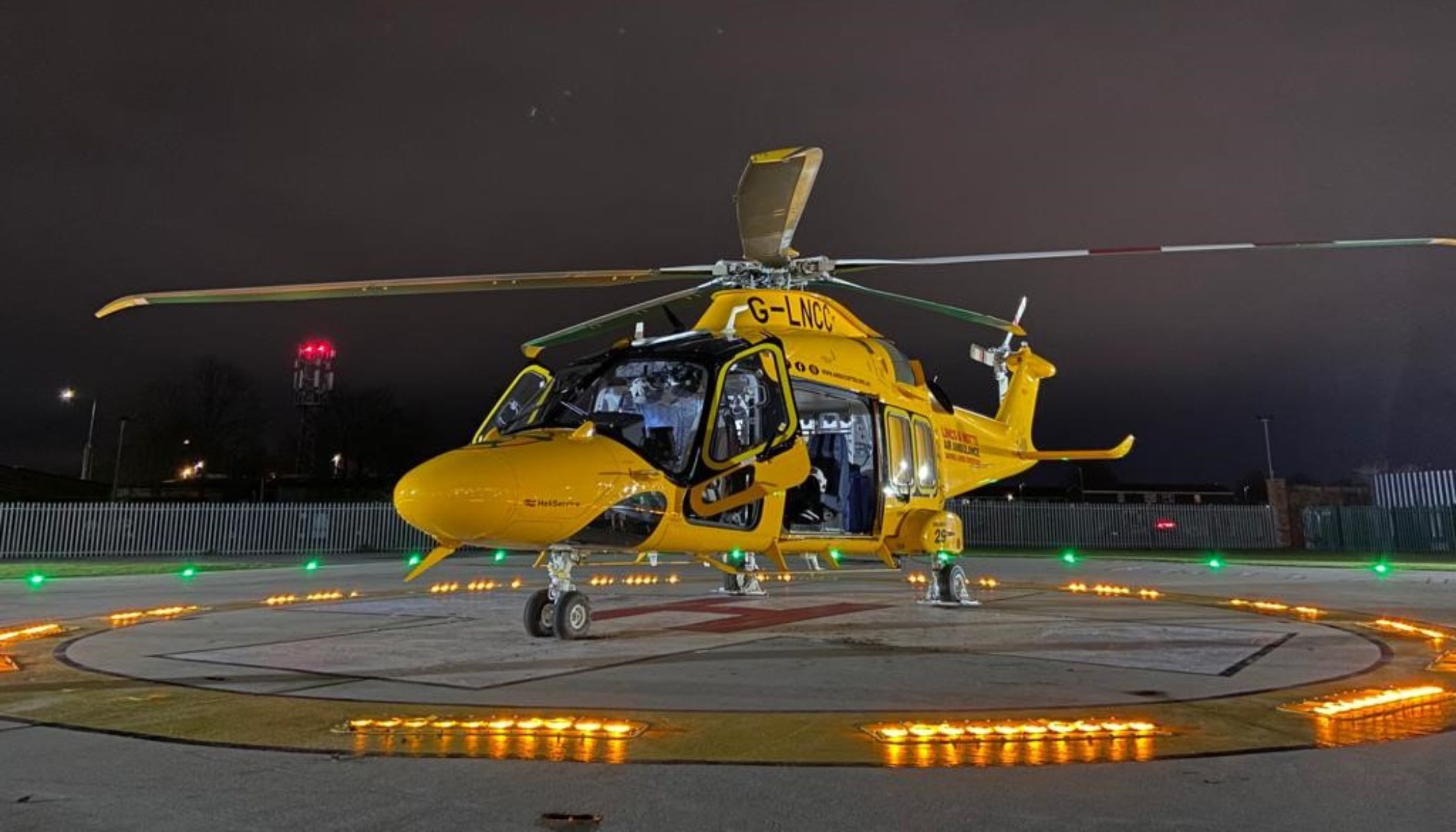 Helicopter on a helipad at night