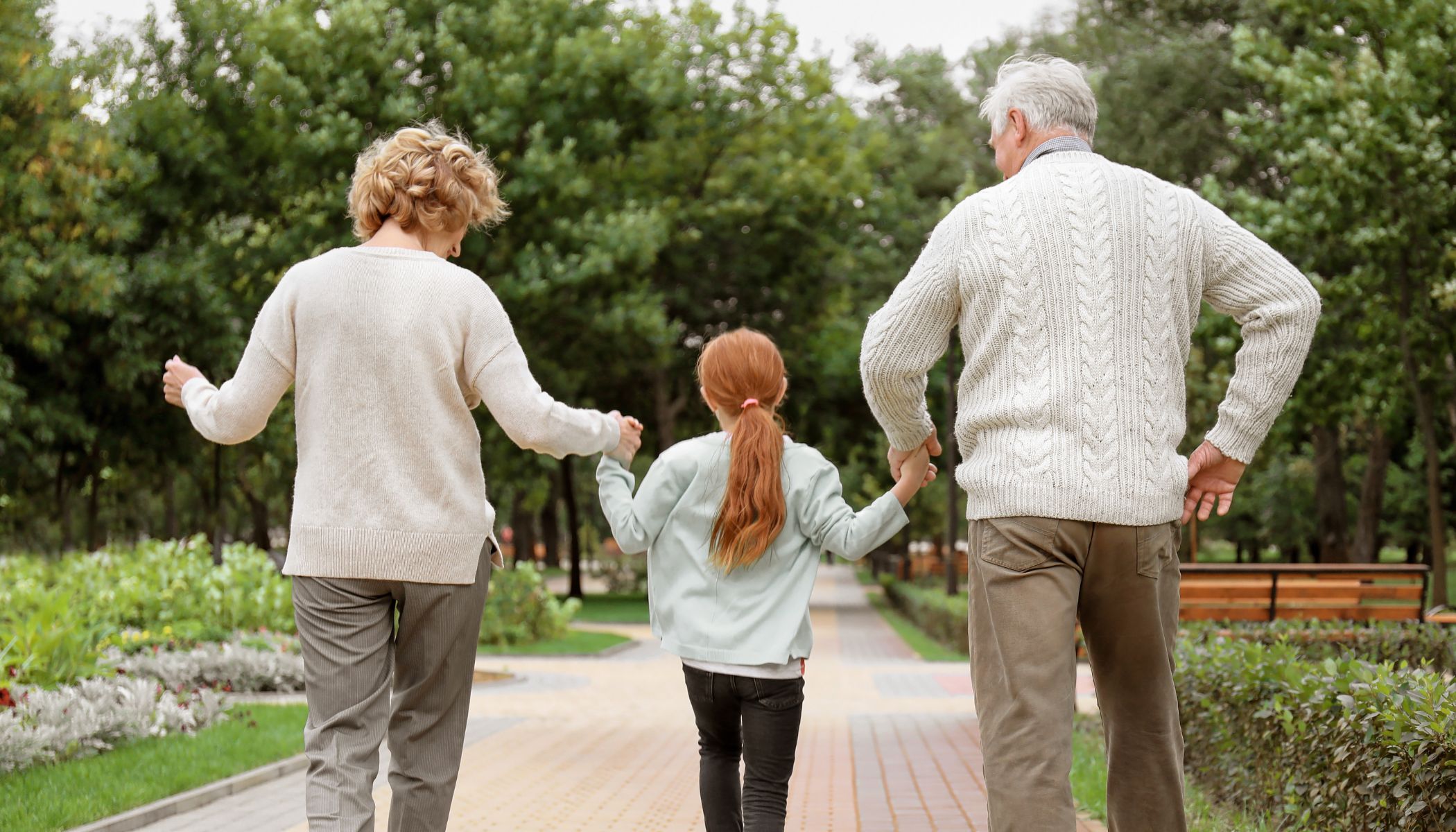 Grandparents walk with grandchild