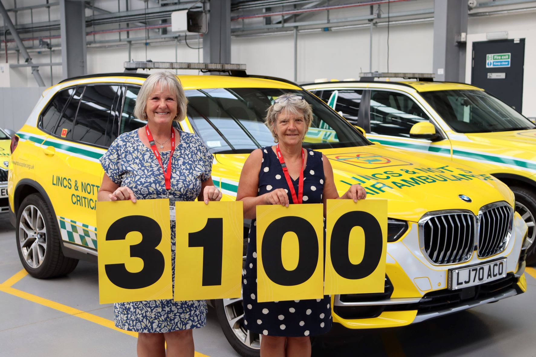 Fundraisers in front of critical care cars