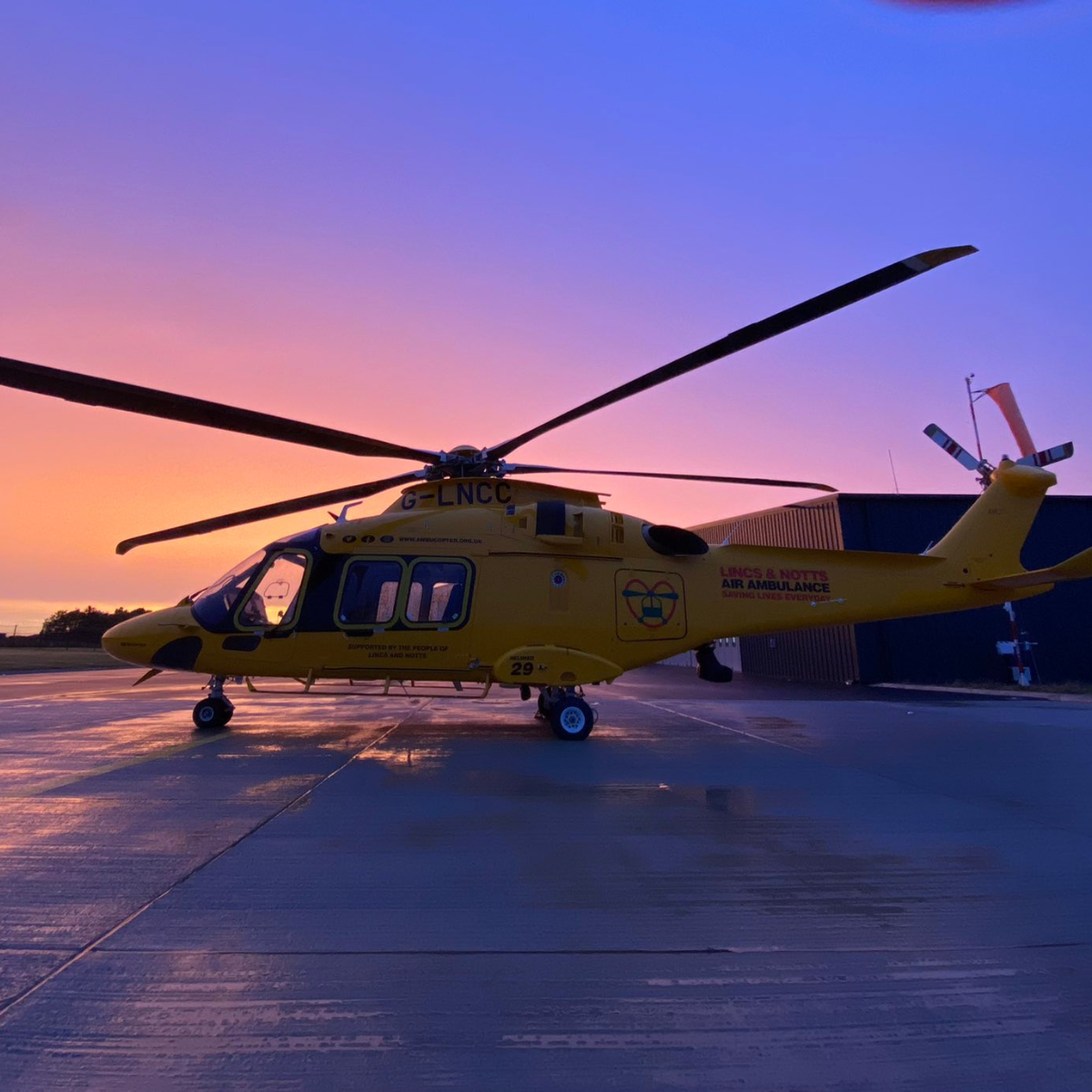 Helicopter on helipad at sunset