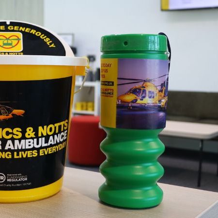 Collection bucket and tin sitting on a desk