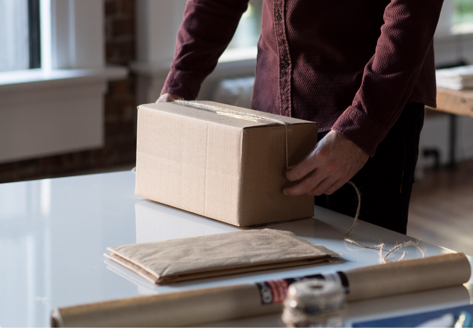 Person wrapping a parcel