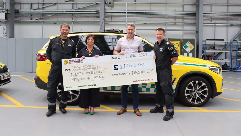 rob cresswell at Mazars gifving cheque to Lincs & NOtts Air Ambulance