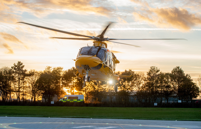 Helicopter taking off at sunset