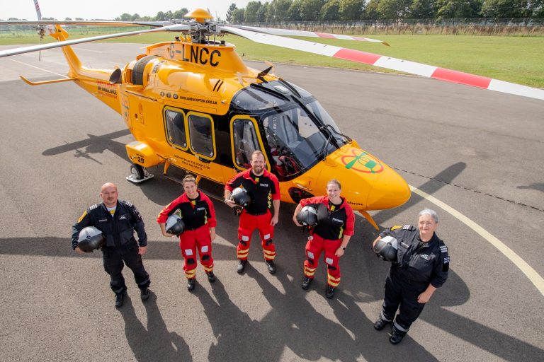 LNAA crew stood in front of the helicopter