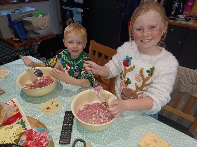 two children making reindeer food for Lincs & Notts Air Ambulance