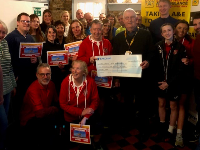 people from Horncastle Running club giving a cheque to Lincs Notts Air Ambualance volunteer