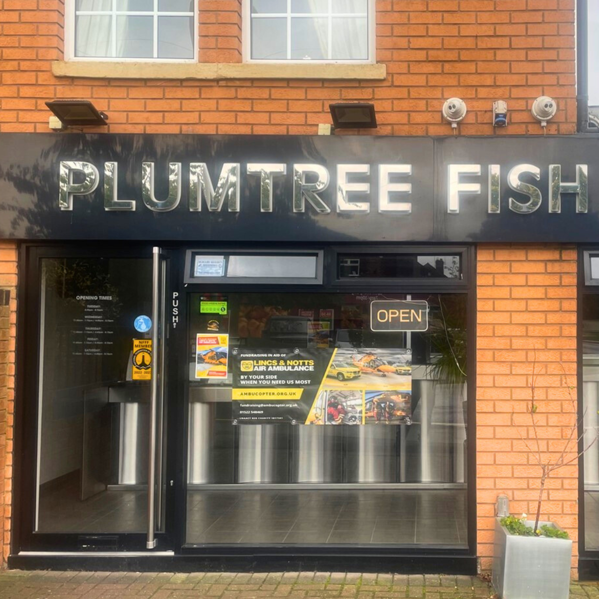 Shop front with LNAA poster and banner displayed