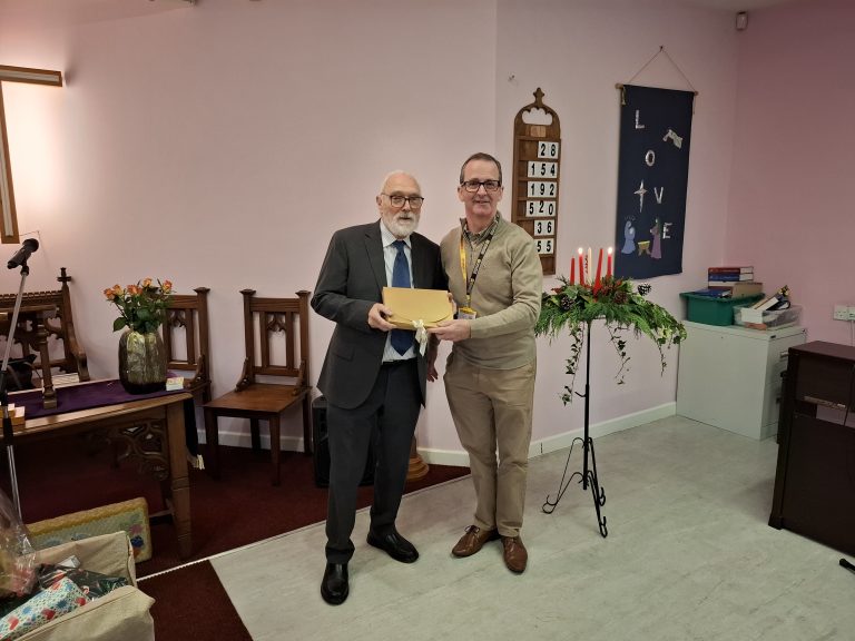 David Carrick, volunteer at LNAA accepting cheques from Scunthorpe Congregational Church