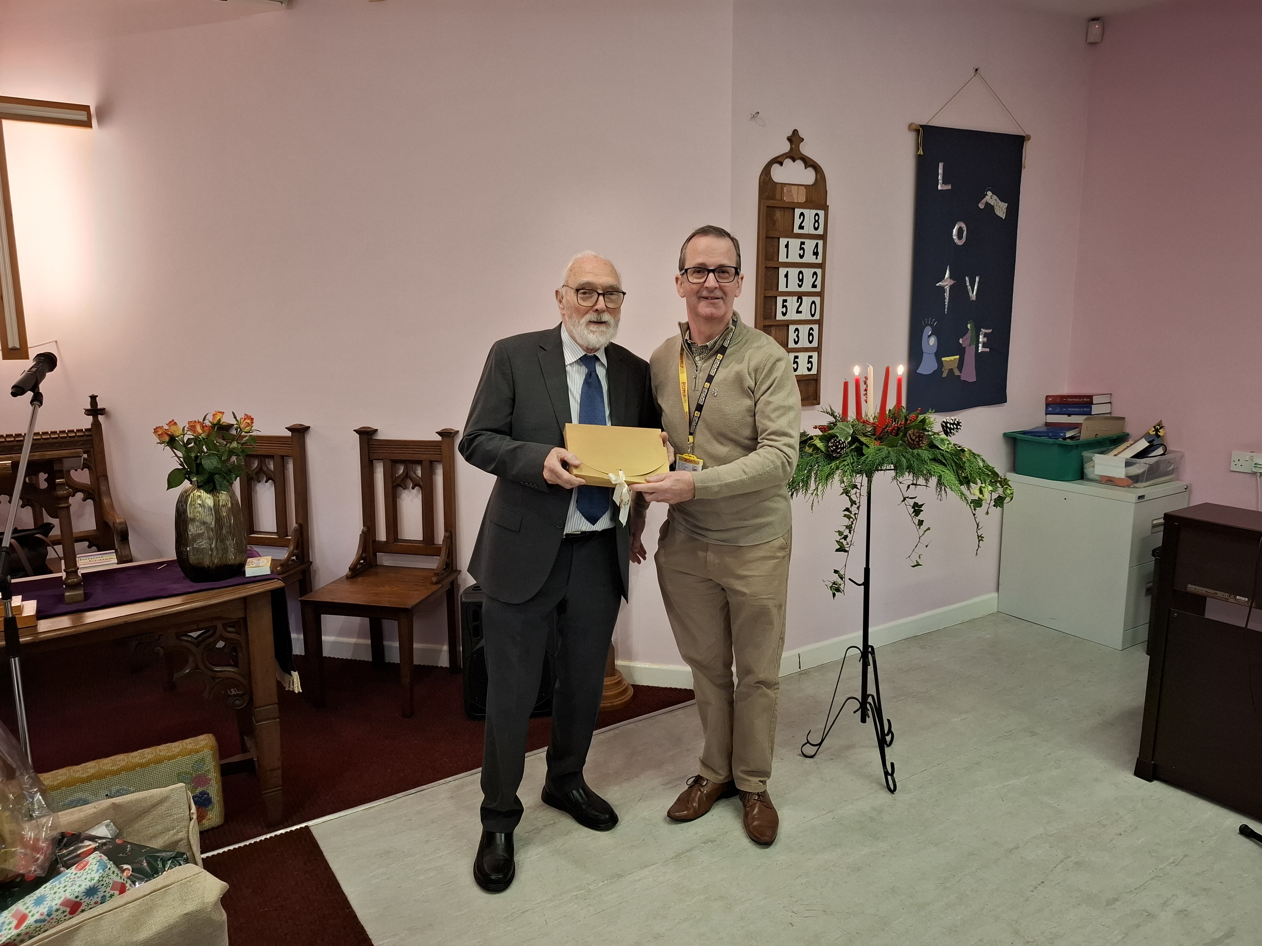 David Carrick, volunteer at LNAA accepting cheques from Scunthorpe Congregational Church